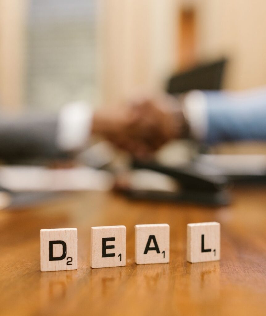 Deal tiles symbolising successful negotiation, client agreement, and wealth advisory business growth.